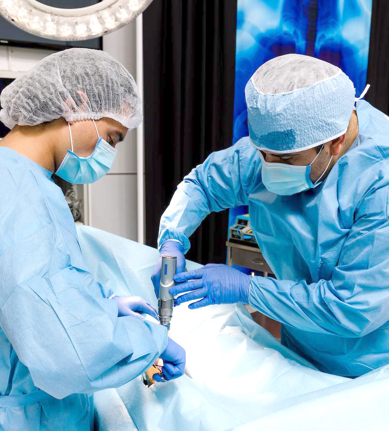 students practicing on cadaver dummy