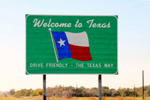 Welcome sign with Texas Flag